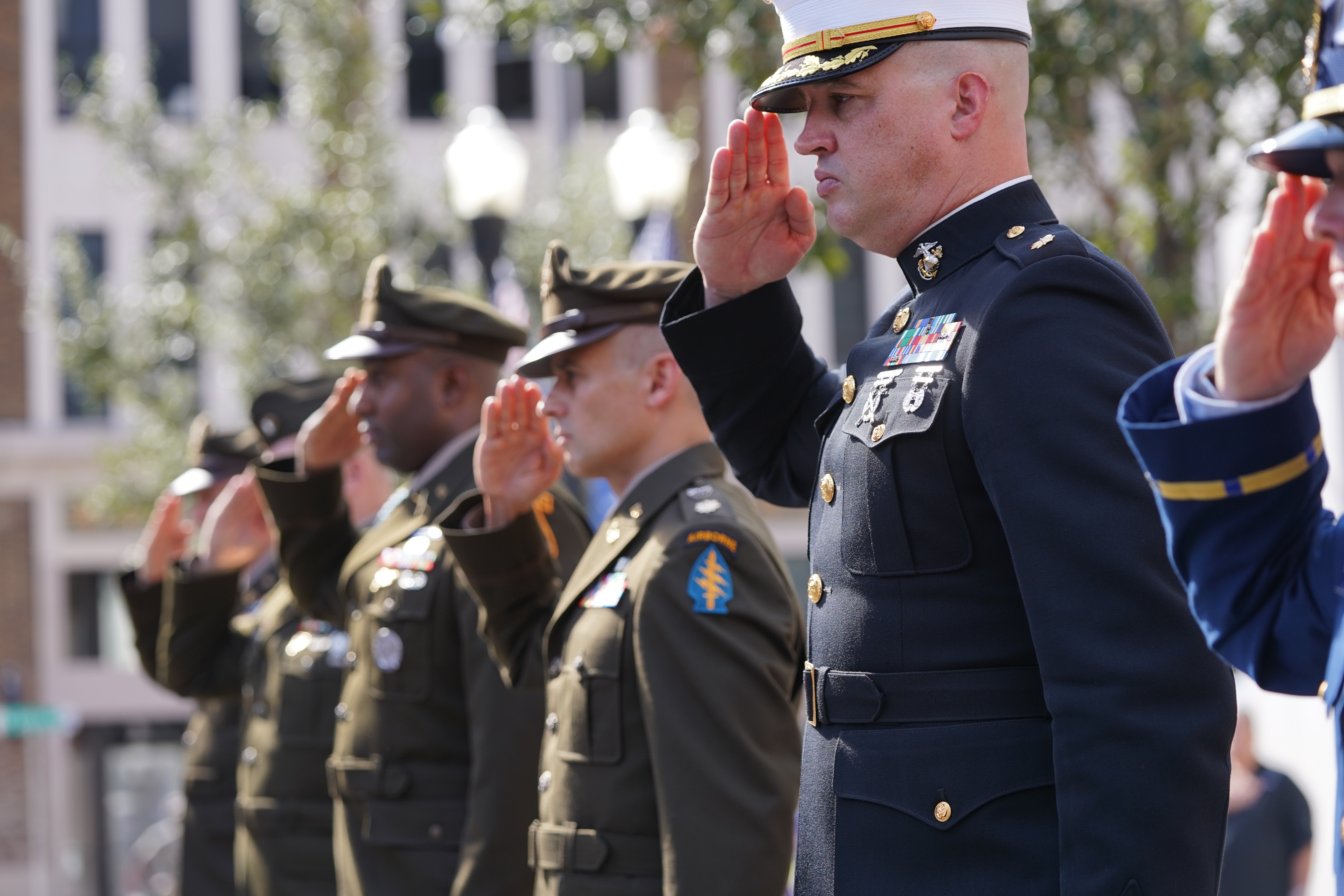 Veterans in uniform saluting before the start of the parade