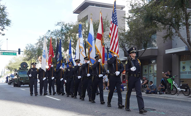 OPD Honor Guard marching in downtown Orlando with the American flag