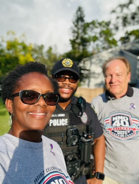 Two city residents taking a selfie with an OPD Officer