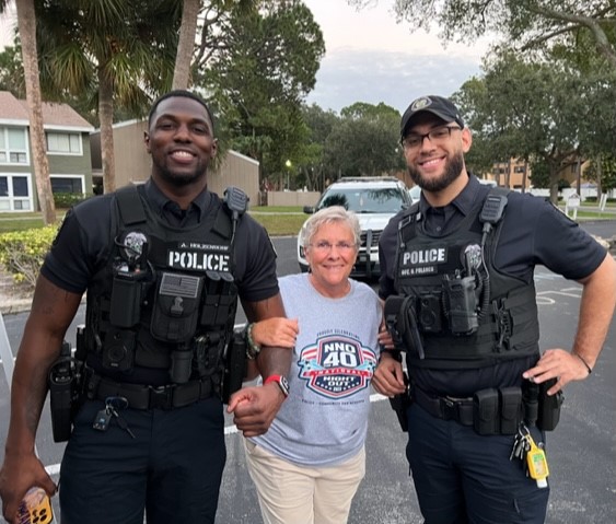 A city resident posing with two OPD Officers