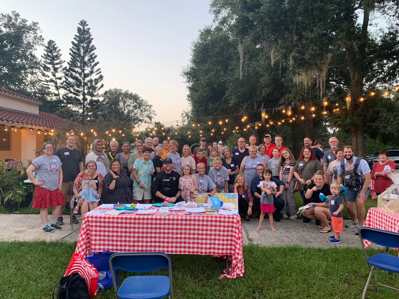 Residents and OPD Officers posing for a group photo at an NNO Block Party