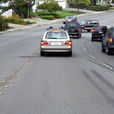 A photo of a roadway with ceramic markers outlining travel lanes.