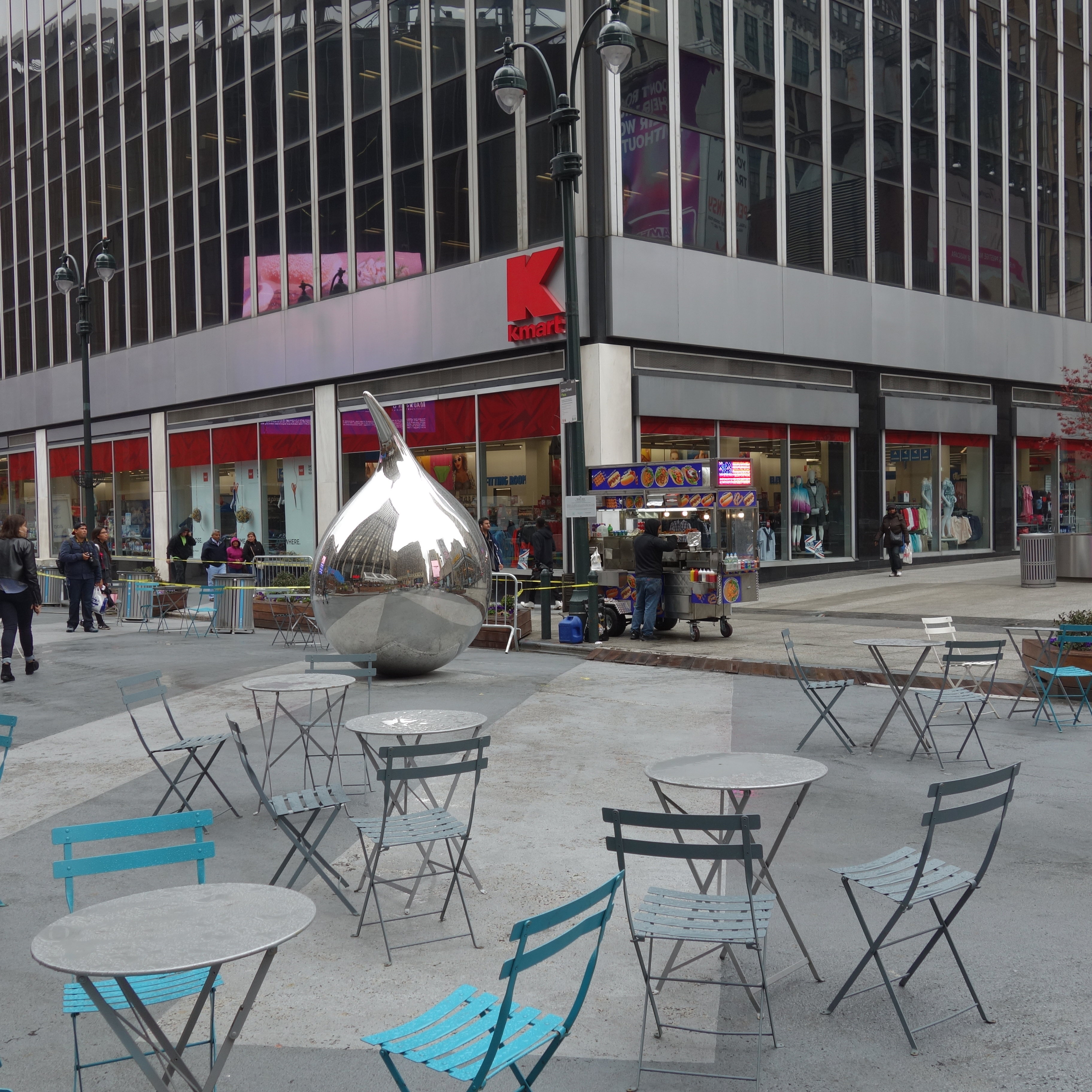 A picture of a quick-build plaza with street furniture including tables and chairs.