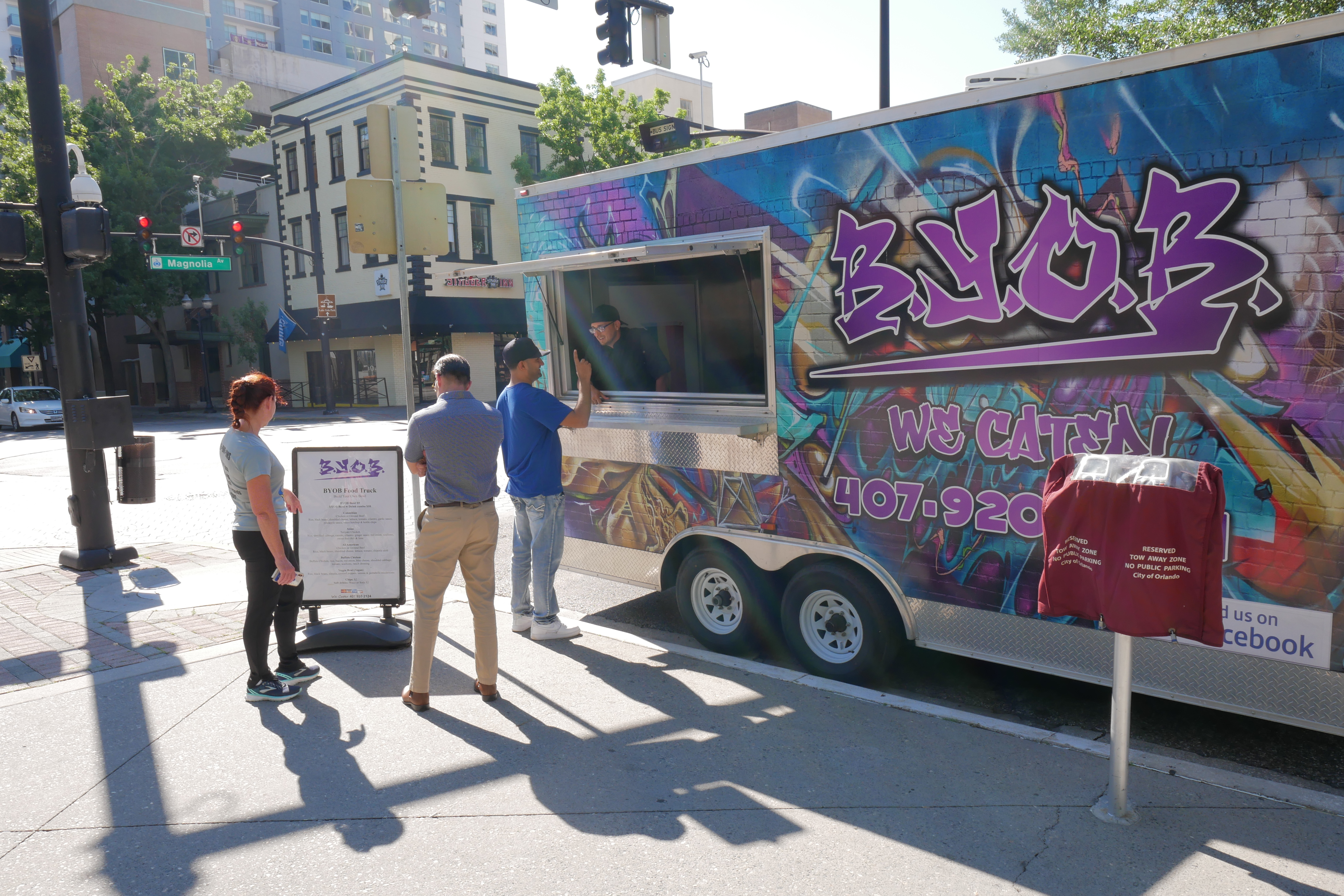 people lined by food trucks